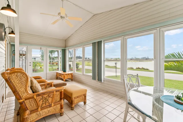 a living room with furniture and floor to ceiling windows
