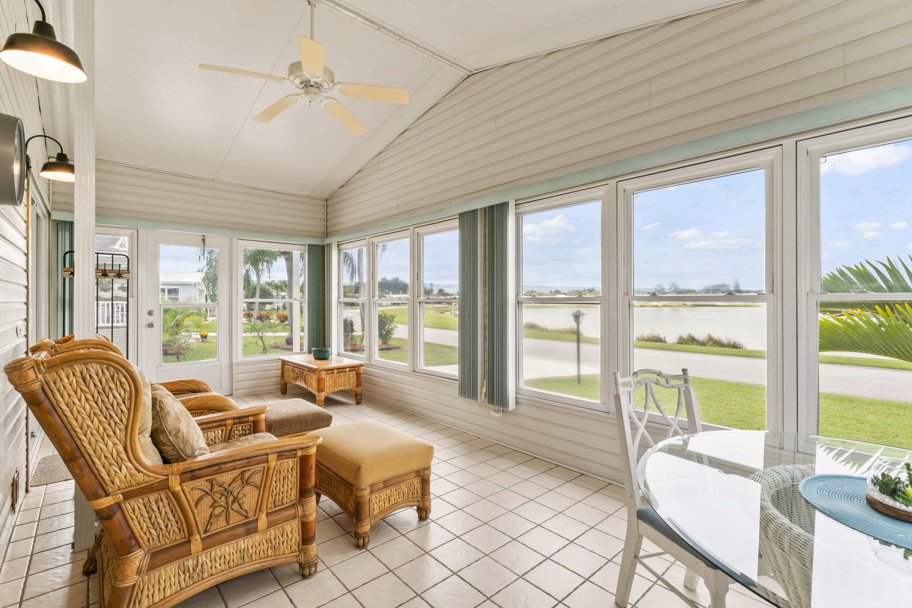 8913 Southwest Chevy Circle Stuart, FL 34997 - Photo 3 of 22 a living room with furniture and floor to ceiling windows