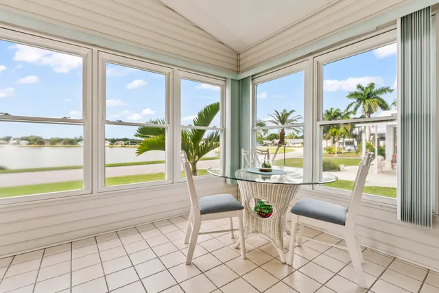 a living room with furniture and floor to ceiling windows