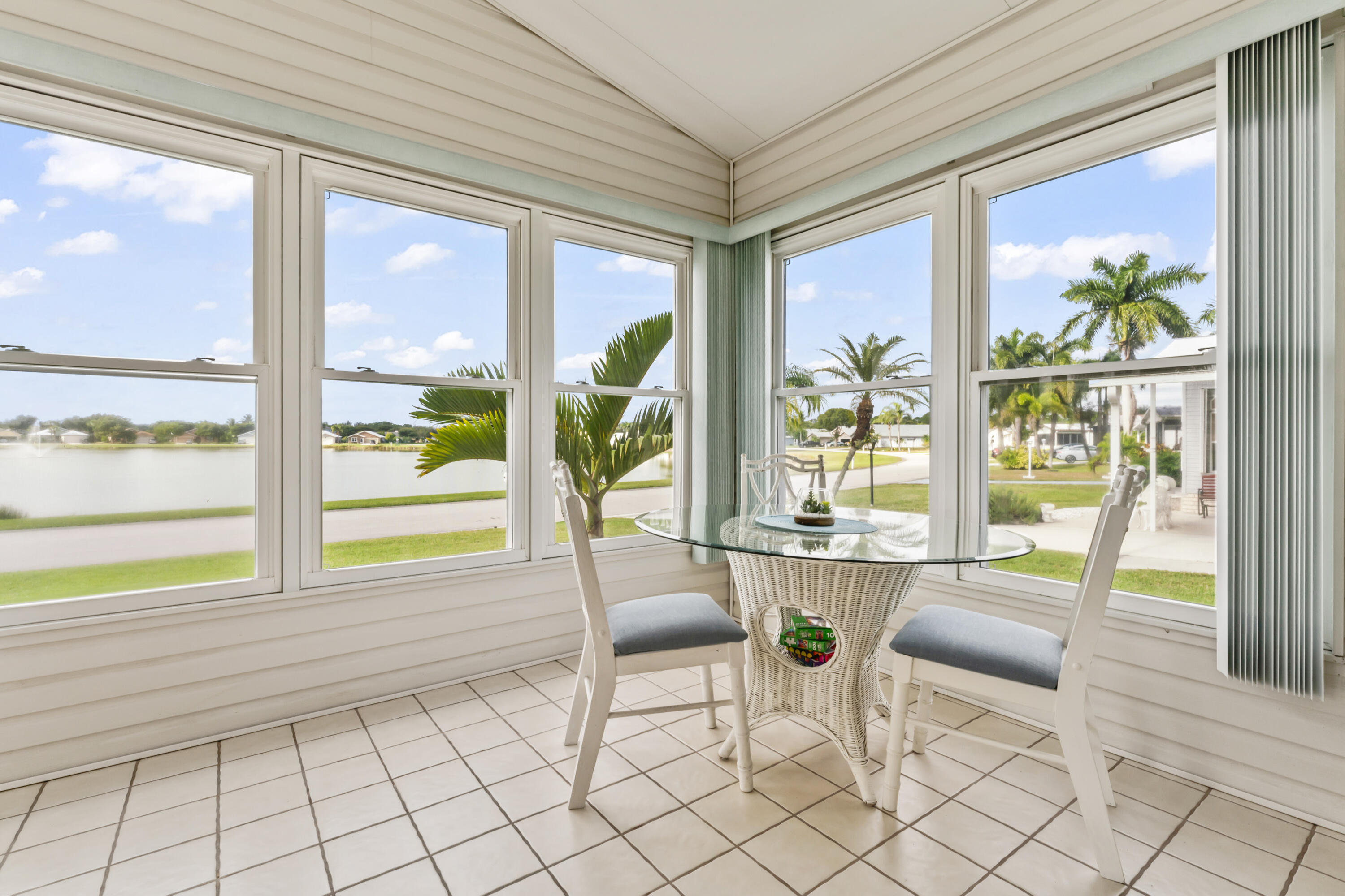8913 Southwest Chevy Circle Stuart, FL 34997 - Photo 4 of 22 a living room with furniture and floor to ceiling windows