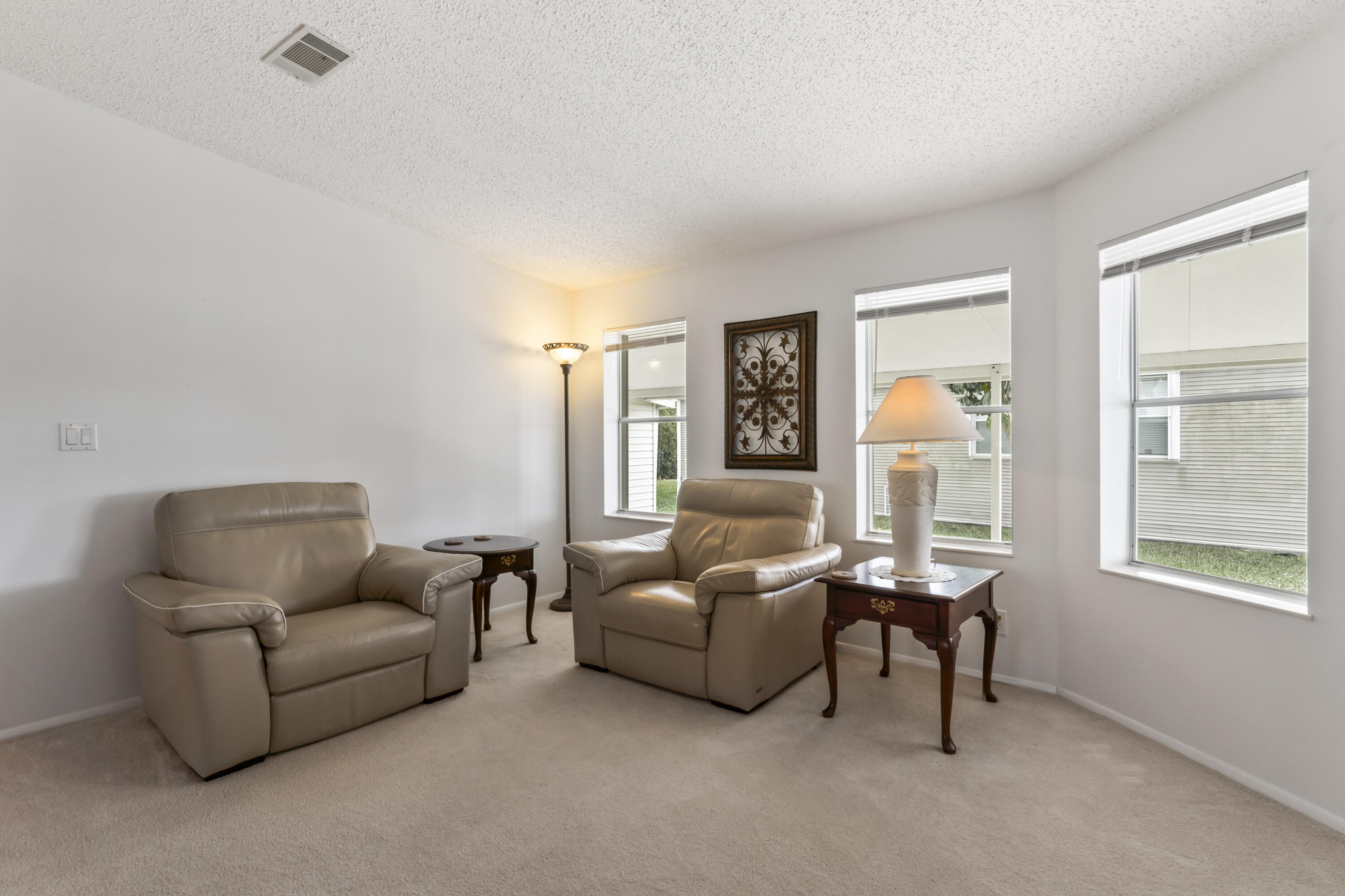 8913 Southwest Chevy Circle Stuart, FL 34997 - Photo 7 of 22 a living room with furniture and a window