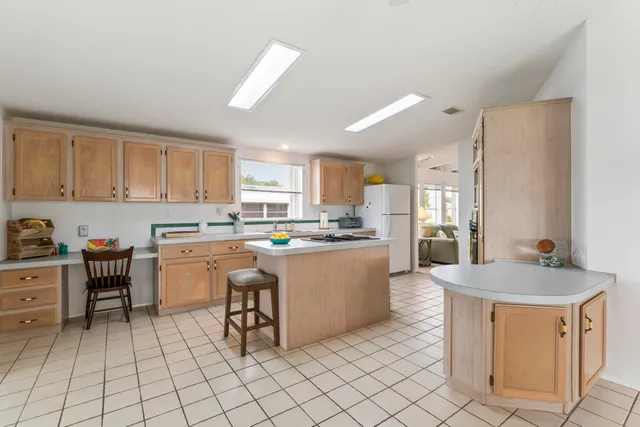 a kitchen with granite countertop cabinets a sink a counter top space and appliances