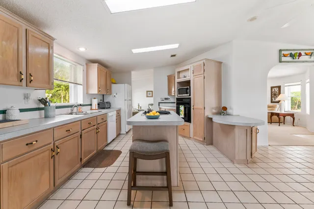 a kitchen with cabinets and chairs