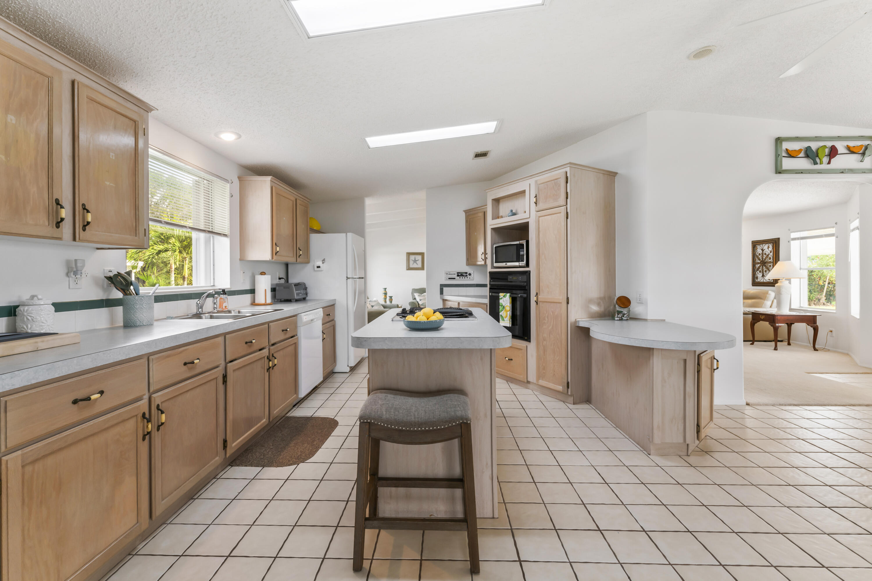 8913 Southwest Chevy Circle Stuart, FL 34997 - Photo 9 of 22 a kitchen with cabinets and chairs