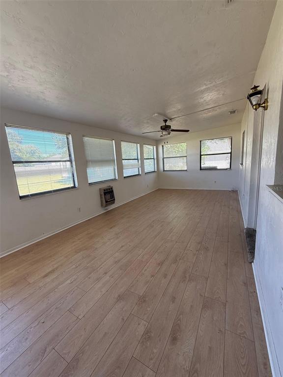9706 Southwest 30th Terrace Ocala, FL 34476 - Photo 11 of 16 an empty room with wooden floor and windows