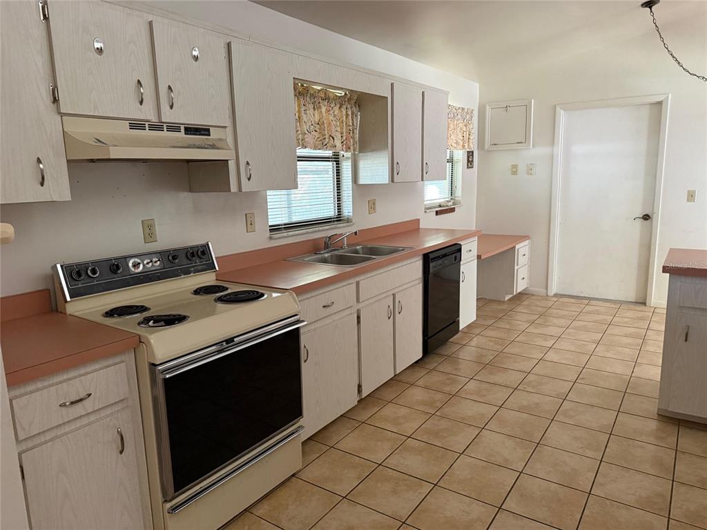 9706 Southwest 30th Terrace Ocala, FL 34476 - Photo 3 of 16 a kitchen with stainless steel appliances a stove a sink and a refrigerator