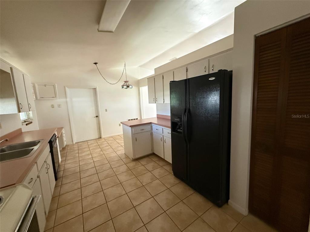 9706 Southwest 30th Terrace Ocala, FL 34476 - Photo 4 of 16 a kitchen with a sink and refrigerator
