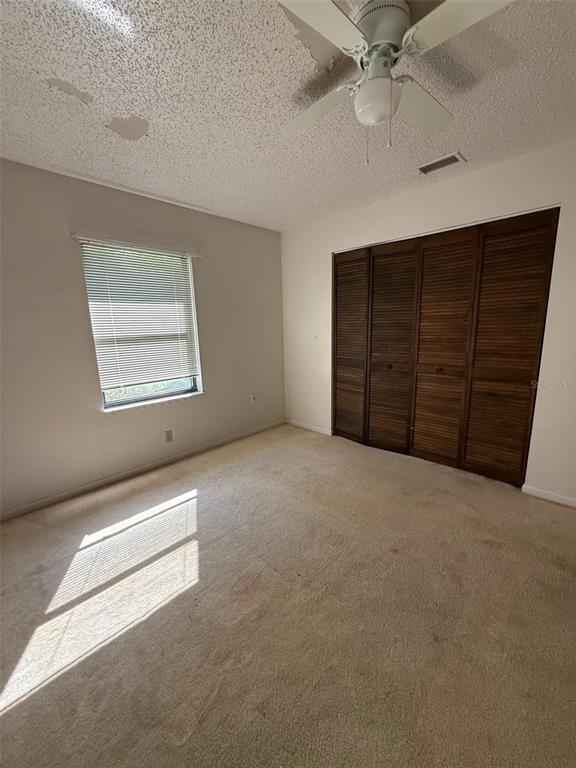 9706 Southwest 30th Terrace Ocala, FL 34476 - Photo 9 of 16 an empty room with a ceiling fan and a window
