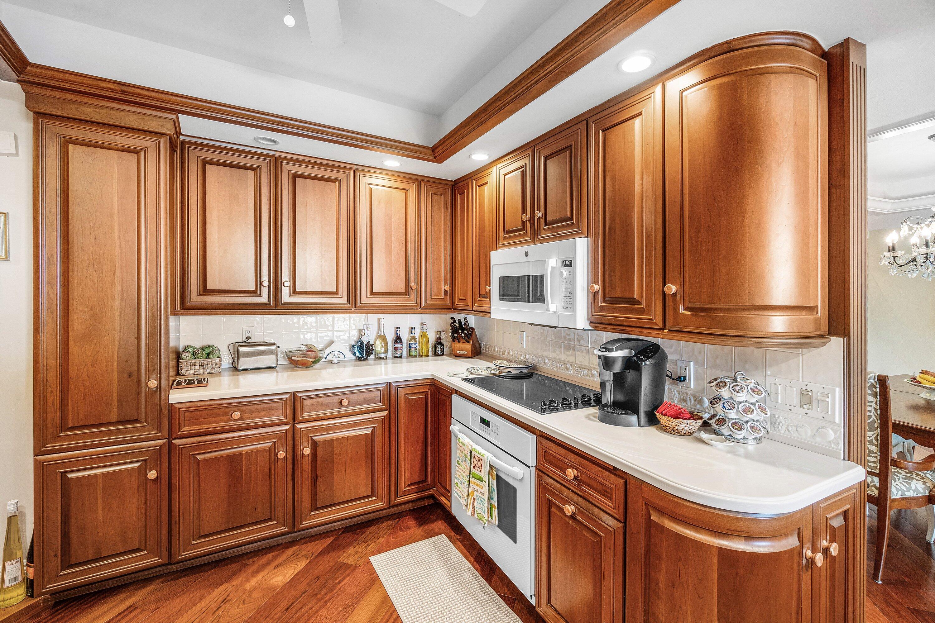 700 South Ocean Boulevard, Unit 804 Boca Raton, FL 33432 - Photo 12 of 39 a kitchen with stainless steel appliances granite countertop a sink a stove and cabinets