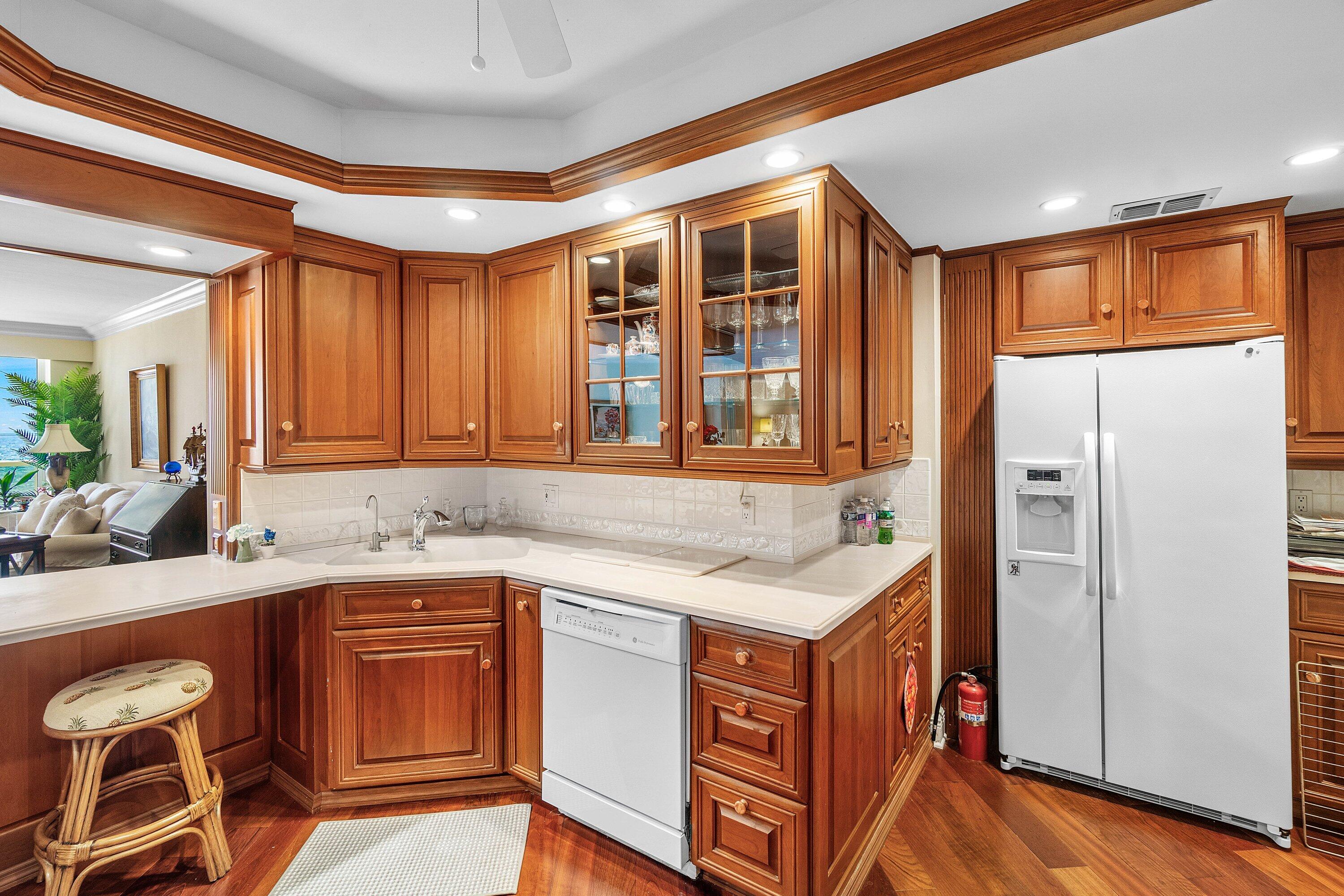 700 South Ocean Boulevard, Unit 804 Boca Raton, FL 33432 - Photo 13 of 39 a kitchen with granite countertop a sink stove and refrigerator