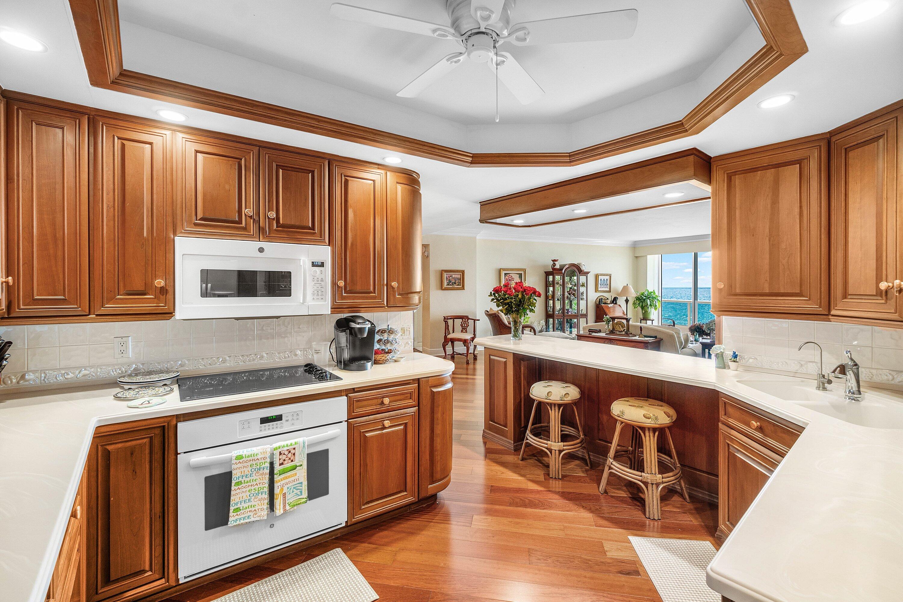 700 South Ocean Boulevard, Unit 804 Boca Raton, FL 33432 - Photo 14 of 39 a kitchen with stainless steel appliances granite countertop a sink and cabinets