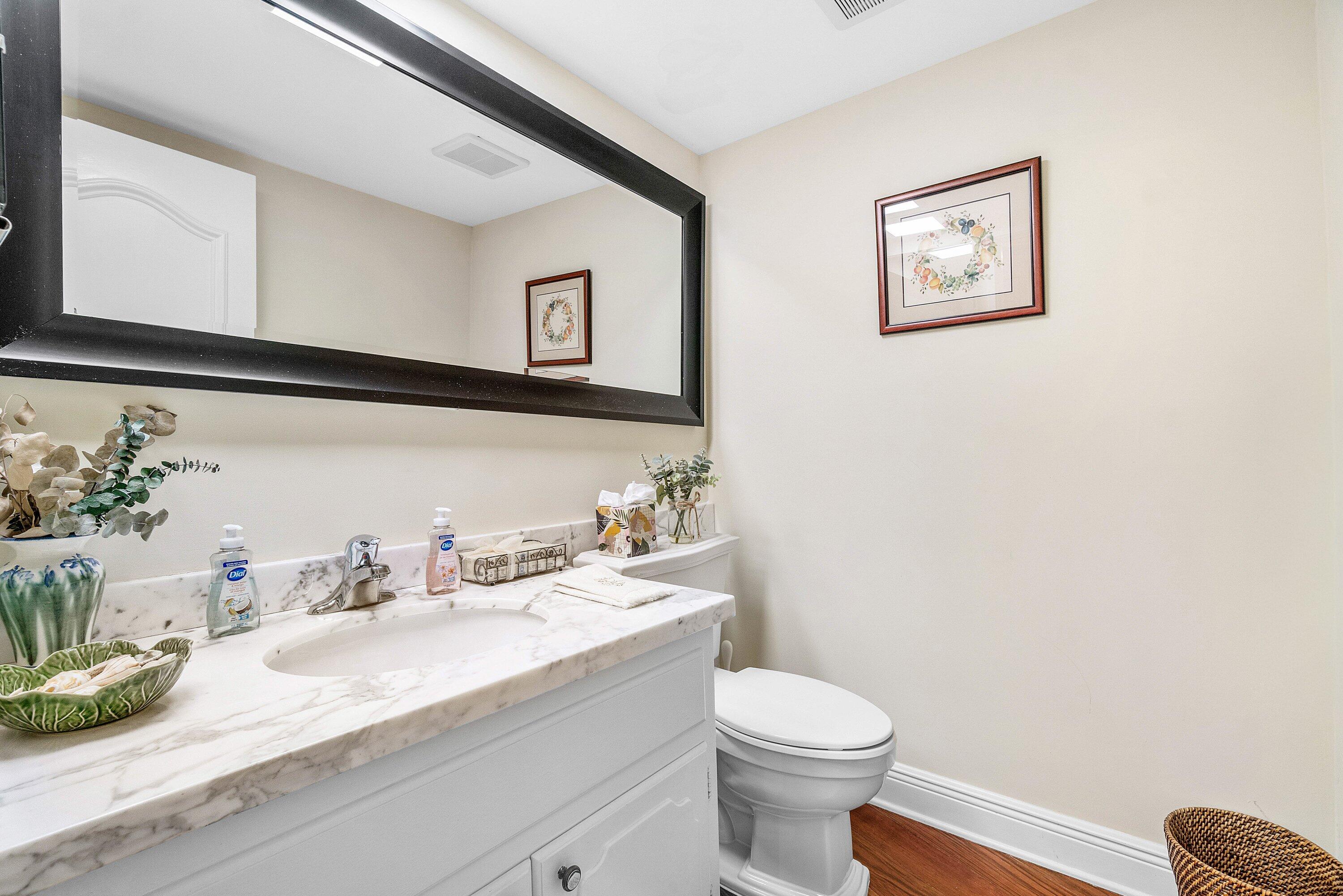 700 South Ocean Boulevard, Unit 804 Boca Raton, FL 33432 - Photo 20 of 39 a bathroom with a granite countertop sink mirror vanity and toilet