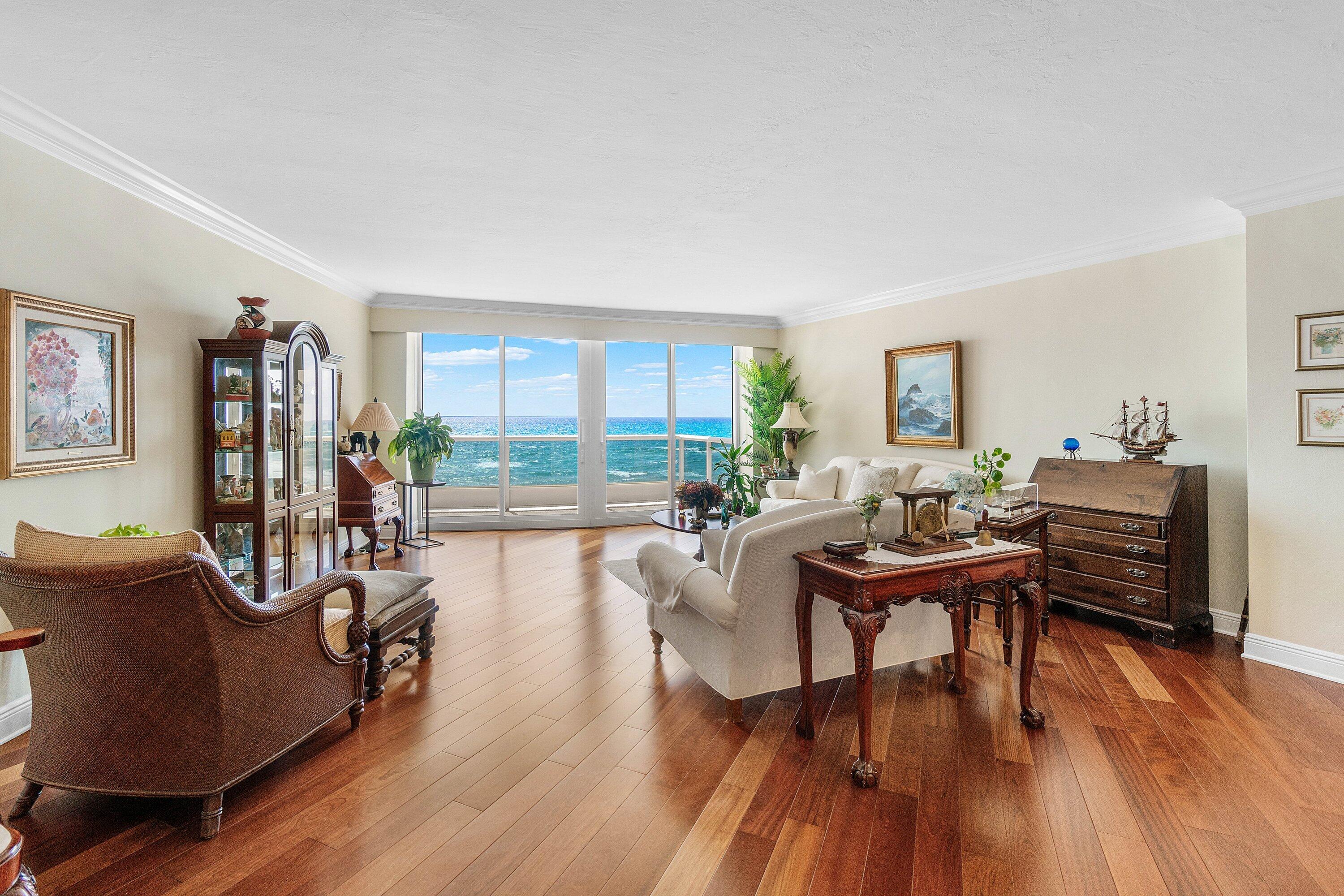 700 South Ocean Boulevard, Unit 804 Boca Raton, FL 33432 - Photo 2 of 39 a living room with furniture and a wooden floor