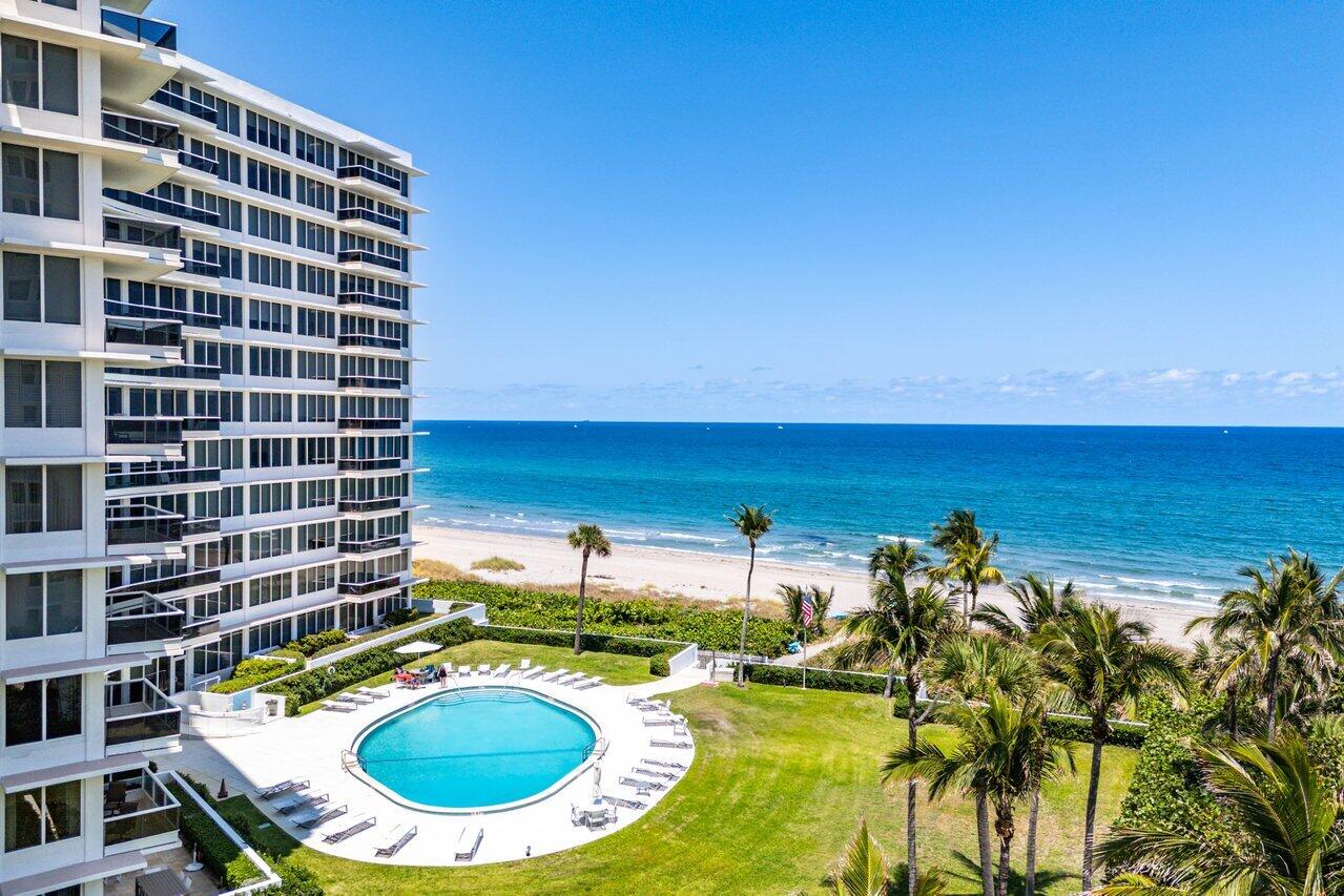 700 South Ocean Boulevard, Unit 804 Boca Raton, FL 33432 - Photo 27 of 39 a view of a swimming pool with outdoor seating and plants