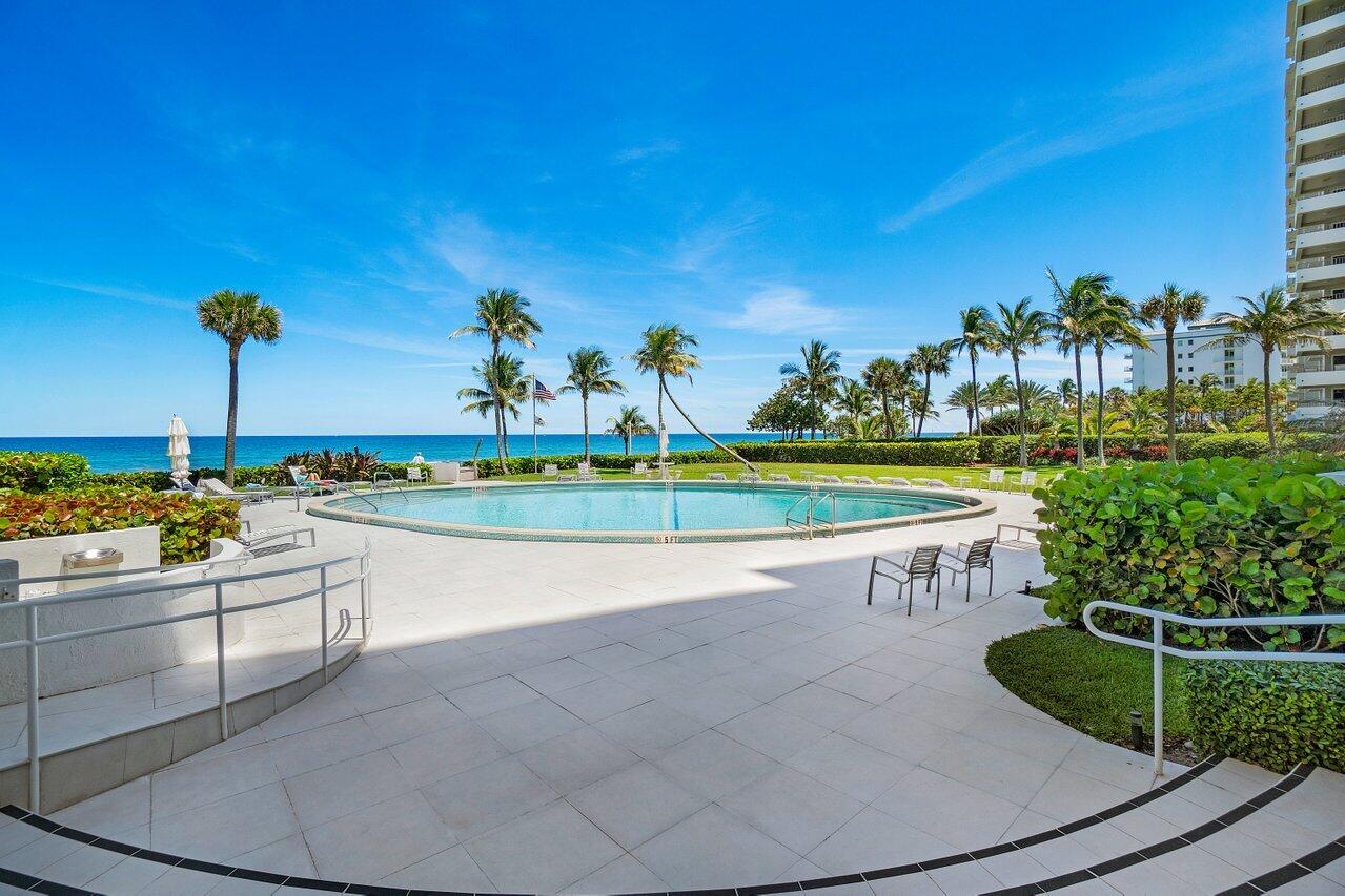 700 South Ocean Boulevard, Unit 804 Boca Raton, FL 33432 - Photo 28 of 39 a view of a swimming pool and outdoor seating