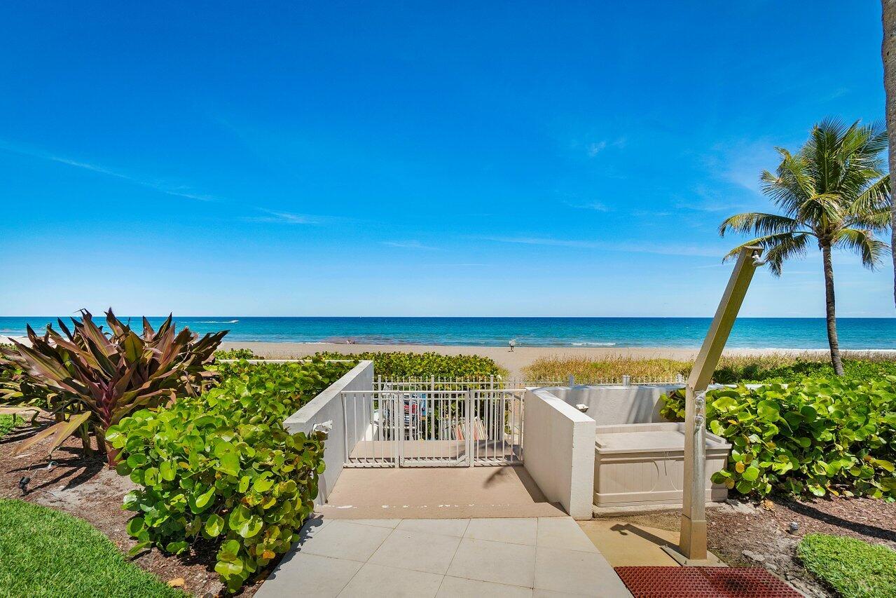 700 South Ocean Boulevard, Unit 804 Boca Raton, FL 33432 - Photo 30 of 39 a view of a patio with a table and chairs under an umbrella