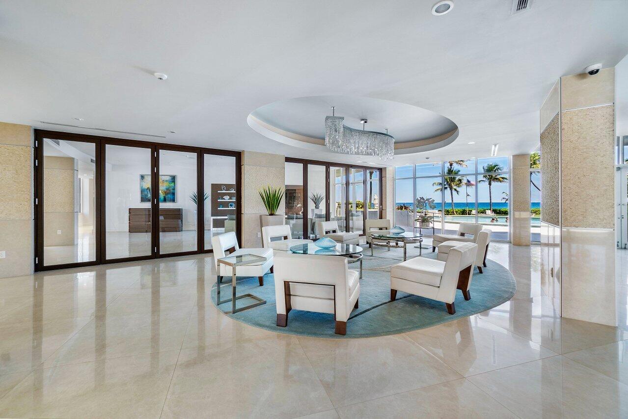 700 South Ocean Boulevard, Unit 804 Boca Raton, FL 33432 - Photo 31 of 39 a living room with fireplace furniture and a large window