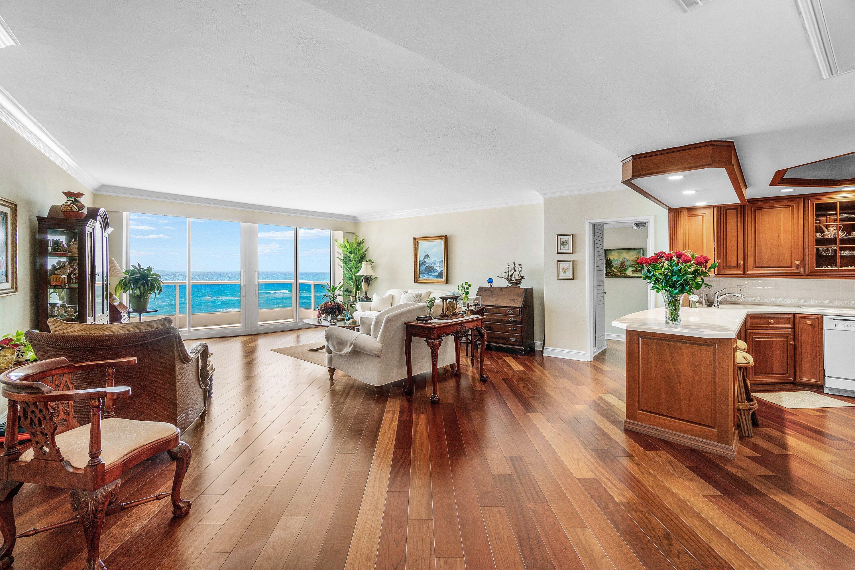 700 South Ocean Boulevard, Unit 804 Boca Raton, FL 33432 - Photo 5 of 39 a living room with furniture dining table and a floor to ceiling window
