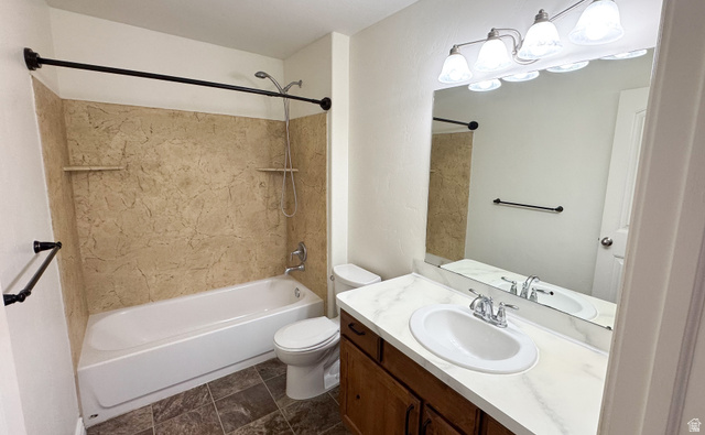 909 South Main Street, Unit F Layton, UT 84041 - Photo 14 of 21 Bathroom featuring a full-sized tub with an integrated shower, a vanity with a white countertop and undermount sink, and a large wall-mounted mirror