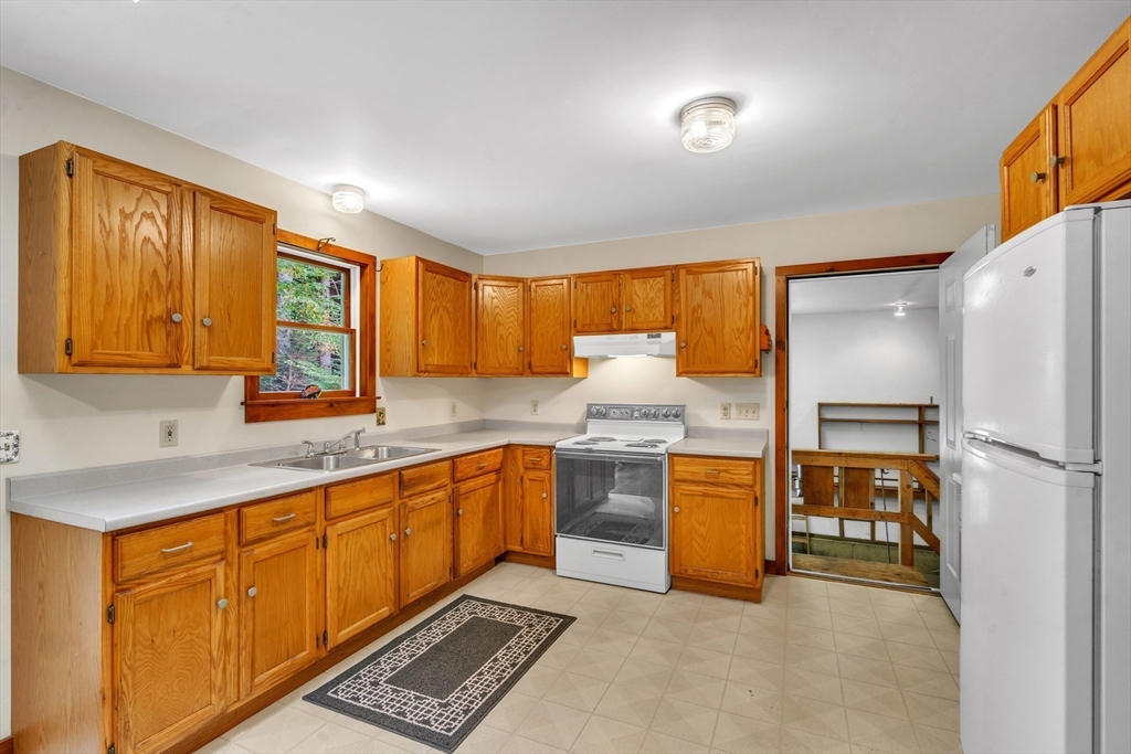 30 Montague Road Sunderland, MA 01375 - Photo 13 of 39 a kitchen with stainless steel appliances granite countertop a sink stove and refrigerator