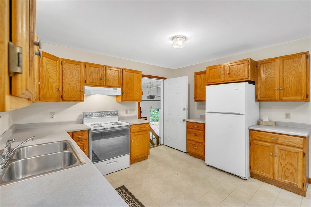30 Montague Road Sunderland, MA 01375 - Photo 14 of 39 a kitchen with stainless steel appliances granite countertop a refrigerator a stove and a sink with large window