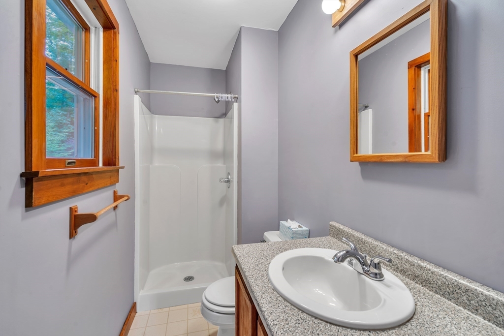 30 Montague Road Sunderland, MA 01375 - Photo 23 of 39 a bathroom with a sink a toilet and a mirror