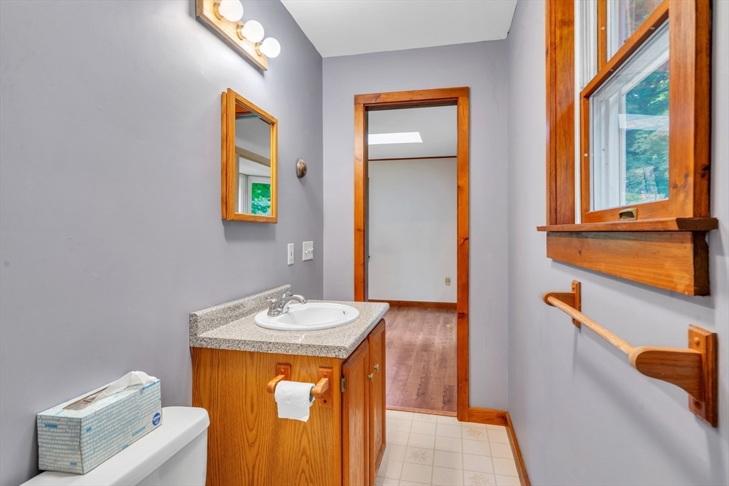 30 Montague Road Sunderland, MA 01375 - Photo 24 of 39 a bathroom with a sink a mirror and a window