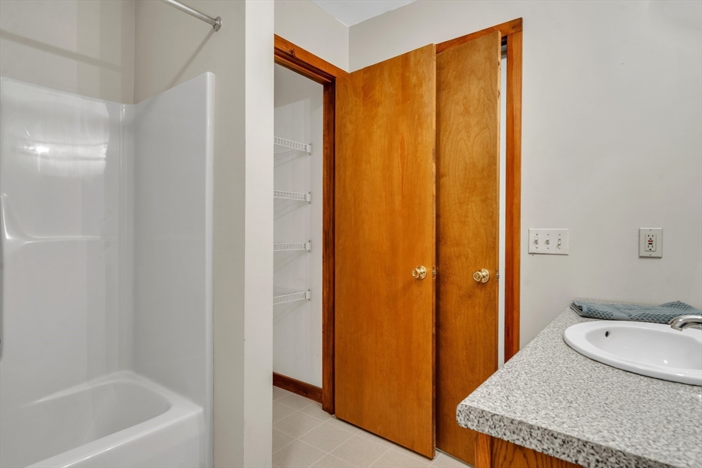 30 Montague Road Sunderland, MA 01375 - Photo 26 of 39 a bathroom with a granite countertop sink and a mirror