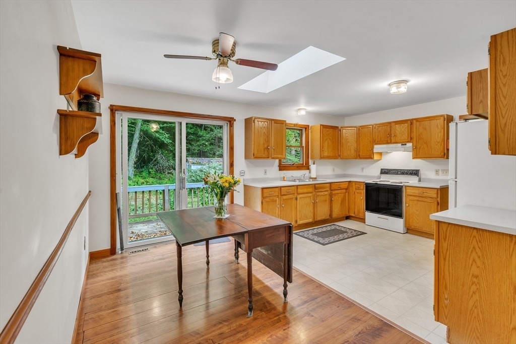 30 Montague Road Sunderland, MA 01375 - Photo 10 of 39 a kitchen with a table chairs refrigerator and microwave