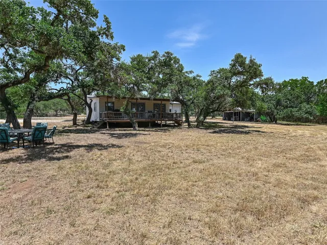 a view of outdoor space with deck and trees