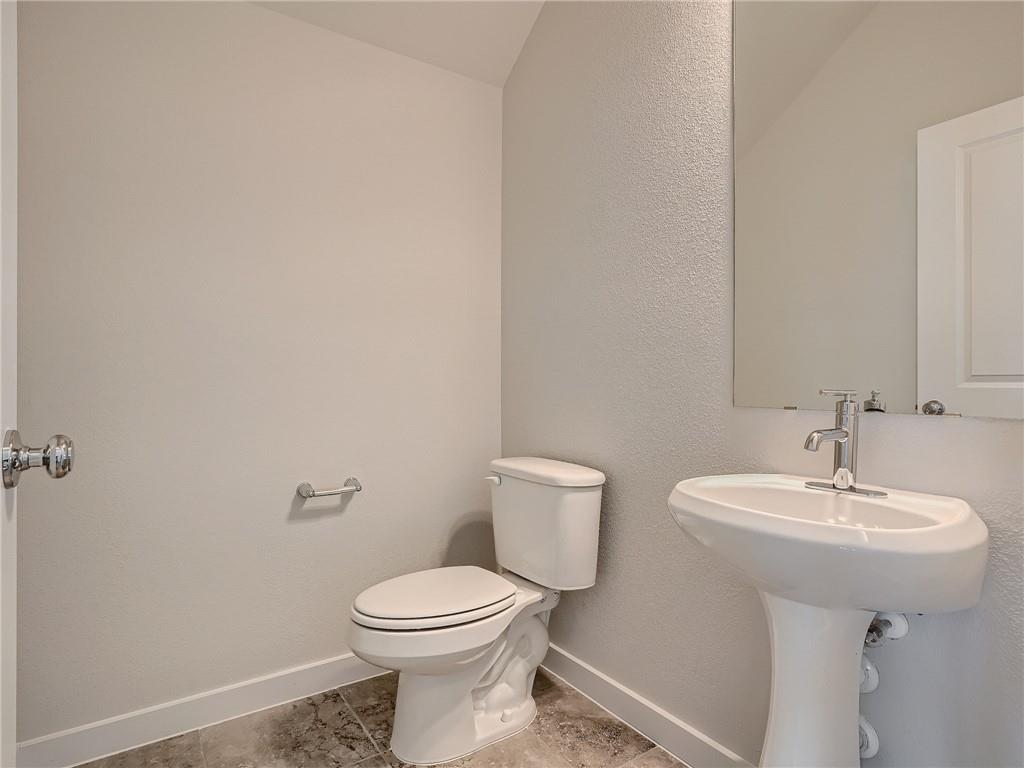1309 Showbox Street, Unit 6 Pflugerville, TX 78660 - Photo 11 of 24 a bathroom with a sink a toilet and mirror