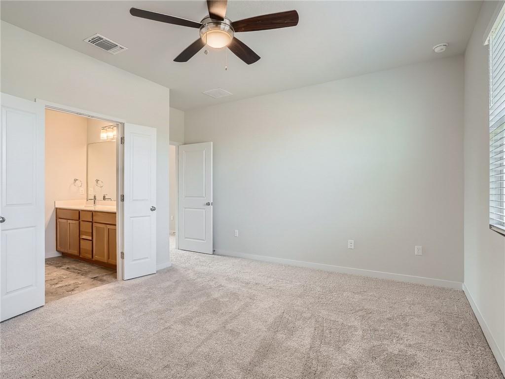 1309 Showbox Street, Unit 6 Pflugerville, TX 78660 - Photo 13 of 24 an empty room with a cabinet and mirrors