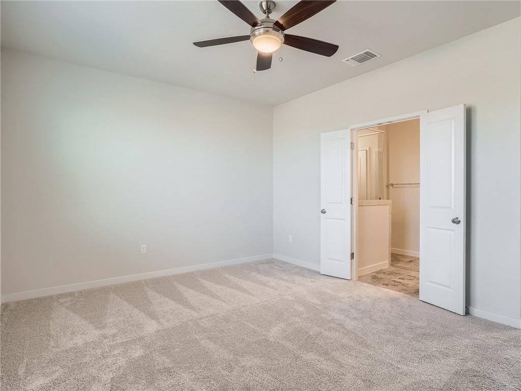 1309 Showbox Street, Unit 6 Pflugerville, TX 78660 - Photo 14 of 24 an empty room with closet and a chandelier fan