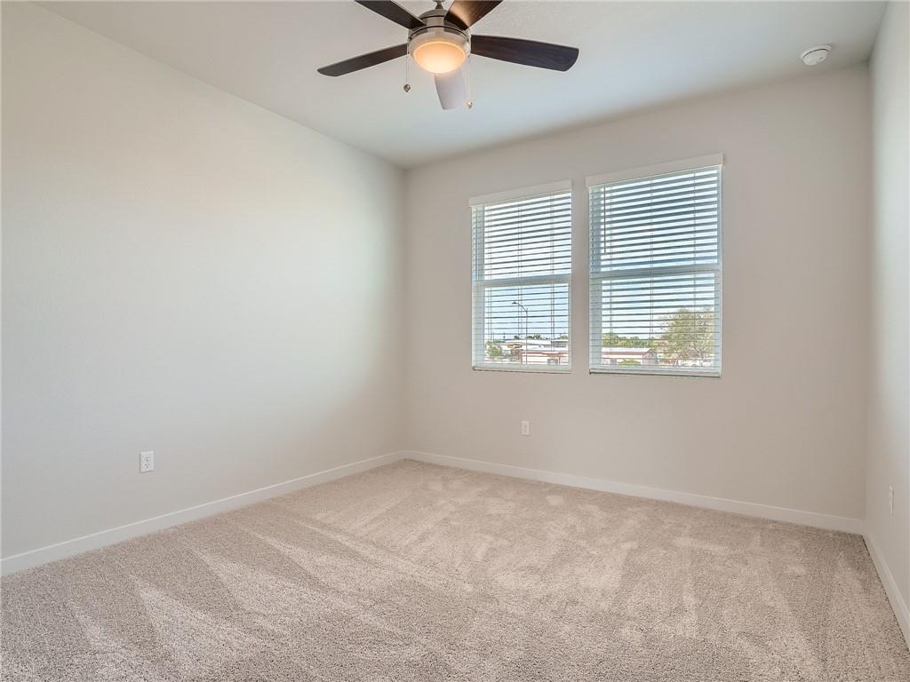 1309 Showbox Street, Unit 6 Pflugerville, TX 78660 - Photo 21 of 24 an empty room with a window and a ceiling fan