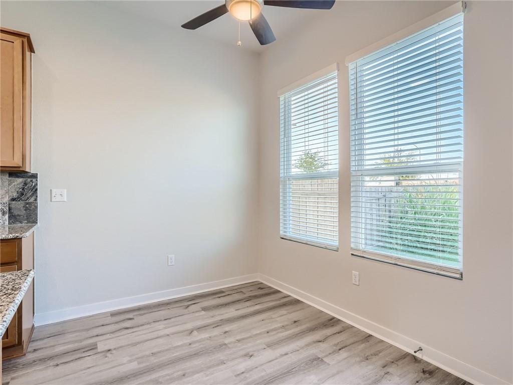 1309 Showbox Street, Unit 6 Pflugerville, TX 78660 - Photo 10 of 24 a view of an empty room with wooden floor and a window