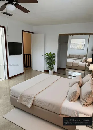 a bedroom with a bed and a television