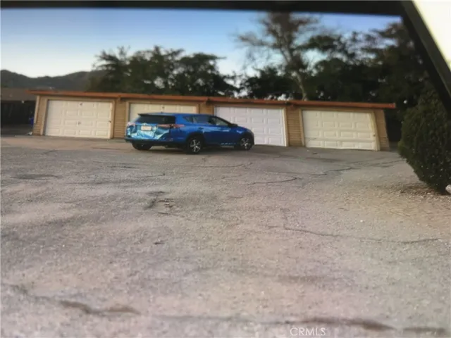 a car parked in front of a white house