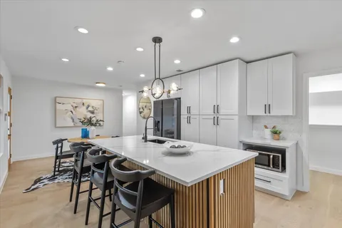 a large kitchen with a table and chairs