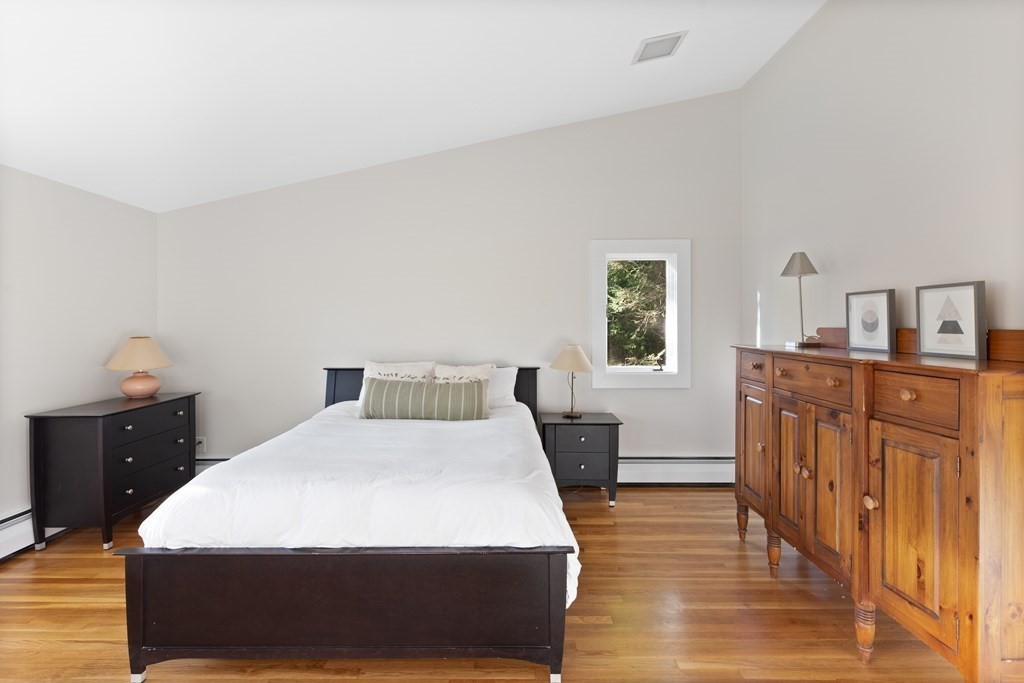 4 Lantern Lane Lexington, MA 02421 - Photo 16 of 29 a bedroom with a bed and wooden floor