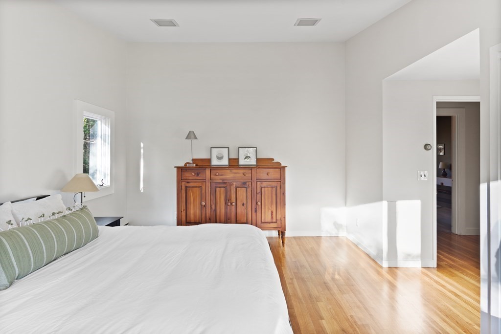 4 Lantern Lane Lexington, MA 02421 - Photo 18 of 29 a bedroom with a bed and a wooden floor
