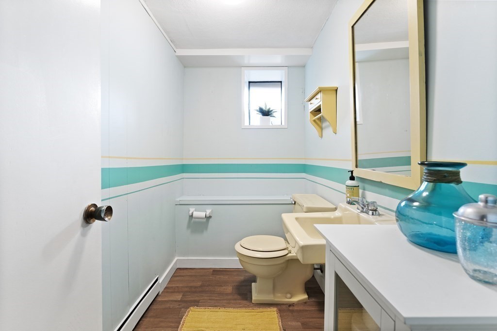 4 Lantern Lane Lexington, MA 02421 - Photo 23 of 29 a bathroom with a sink a toilet and a mirror