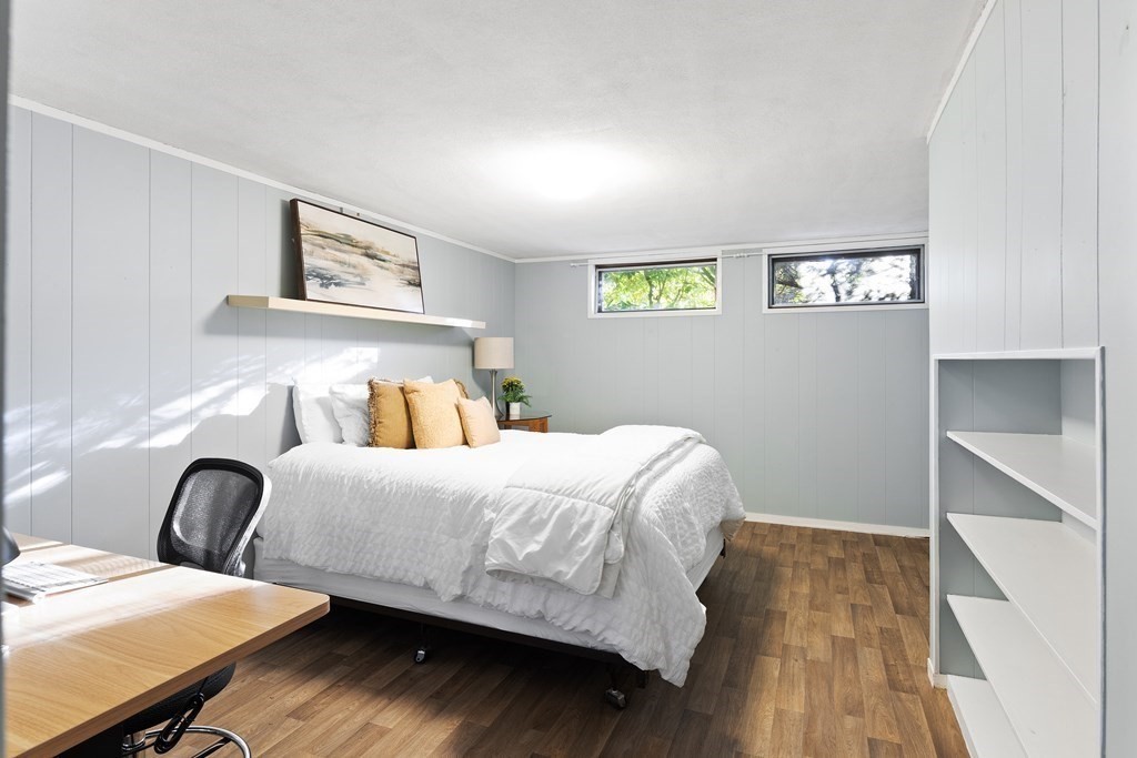 4 Lantern Lane Lexington, MA 02421 - Photo 24 of 29 a bedroom with a bed and wooden floor