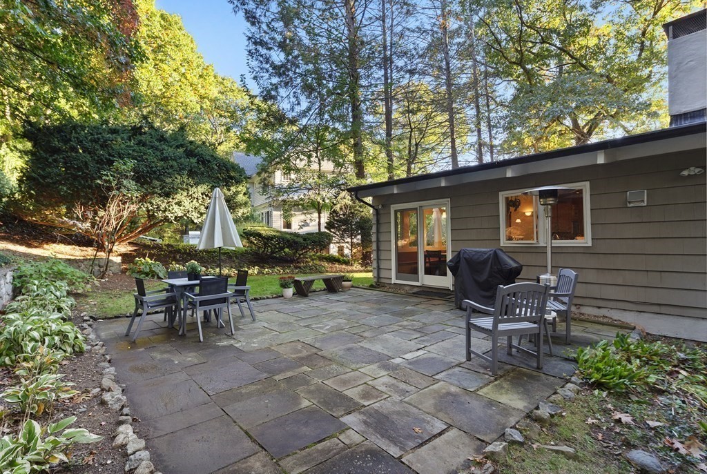 4 Lantern Lane Lexington, MA 02421 - Photo 27 of 29 a view of a patio with table and chairs and floor to ceiling window