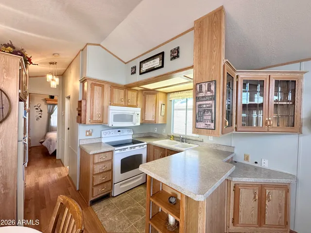a kitchen that has a sink and a stove in it