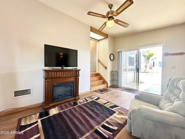 a view of a kitchen with fridge and wooden floor