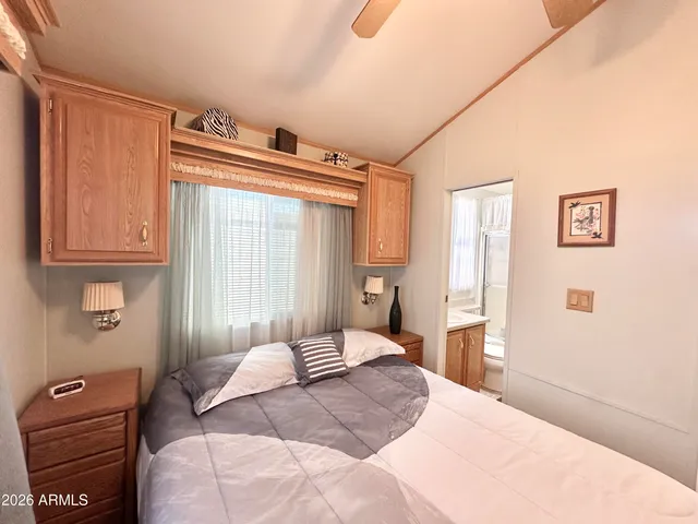 a bedroom with a large bed and a chandelier