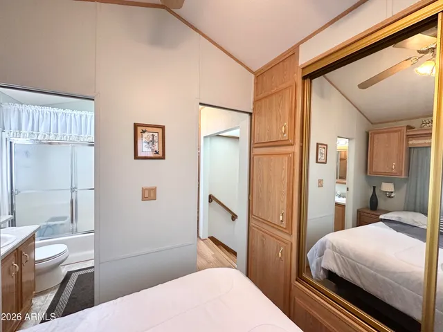a bedroom with a bed and a large window
