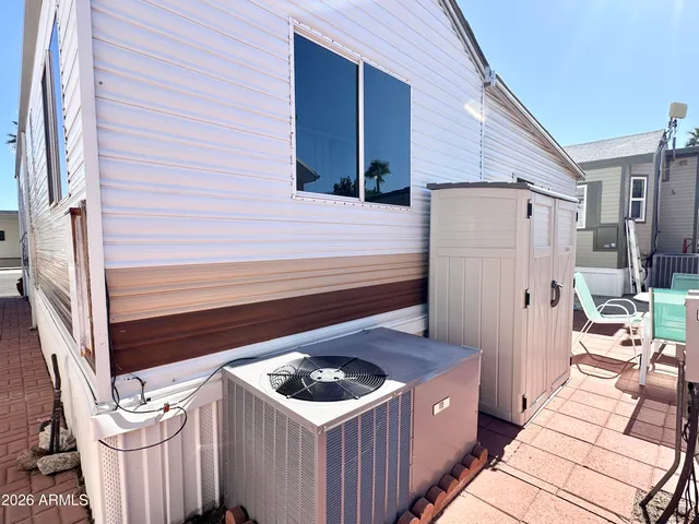 a view of a chairs and table in the back yard of the house
