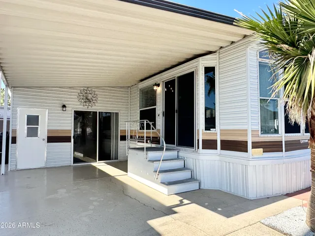 a view of a patio with table and chairs with wooden floor and fence