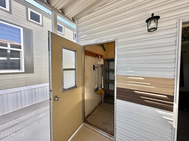 a view of a porch with wooden floor and a ceiling fan